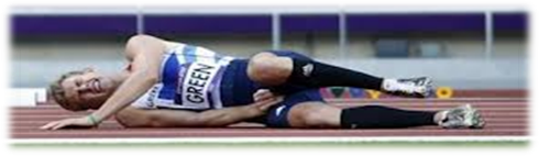 Athlete laying on side on track in pain from injury